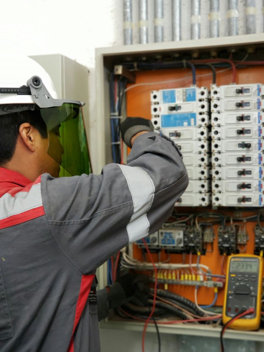 Technician testing a heating system panel